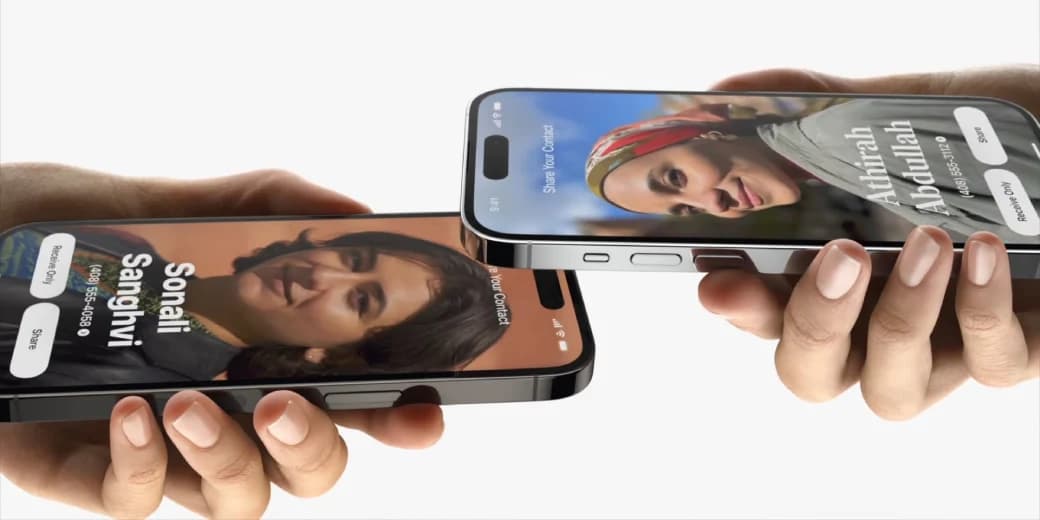 Two smartphones touching to share a contact card using Tap to Share.