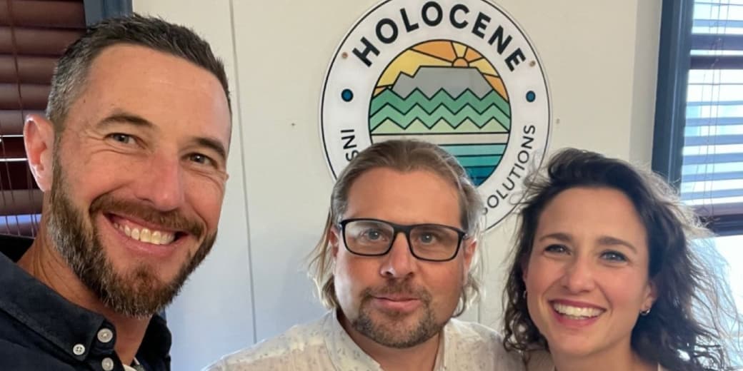Holocene team members pictured in front of a Holocene Investments Solutions sign. Credit: holocene.africa / Instagram.