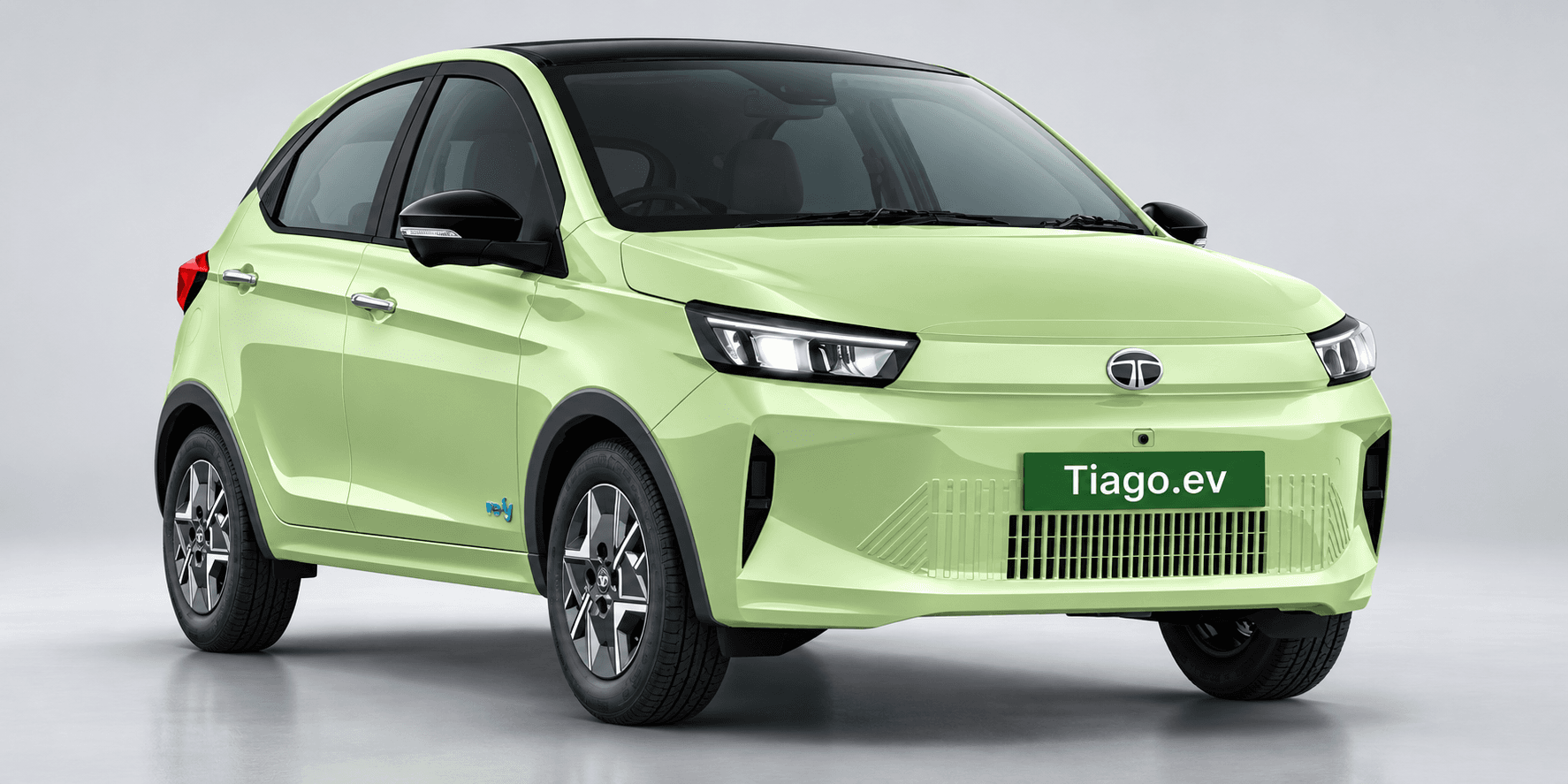 A light green Tata Tiago.ev compact electric car shown against a studio background.
