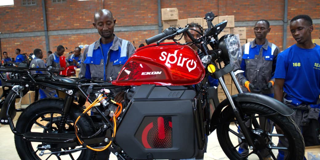 A red Spiro electric motorcycle inside a workshop. Credit: Spiro.