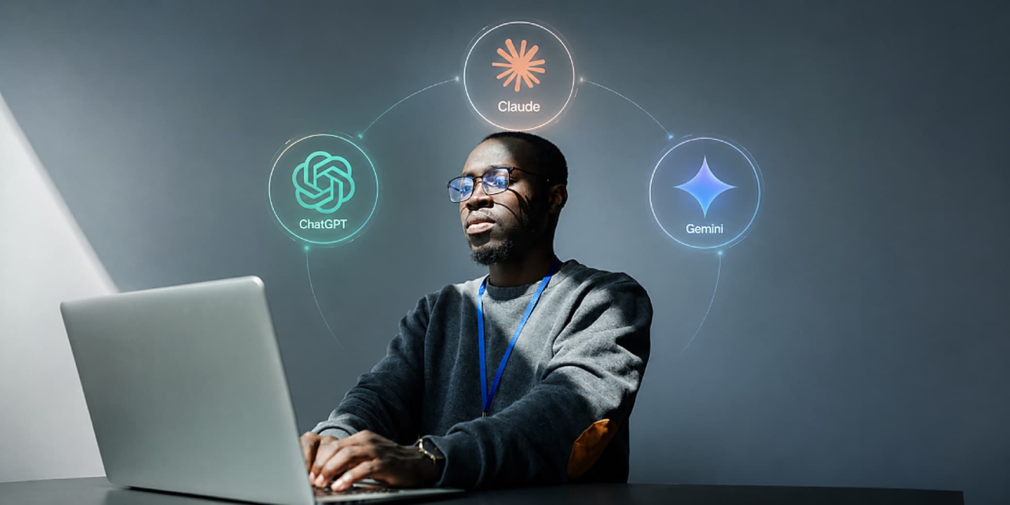 A man working at a laptop with the ChatGPT, Claude, and Gemini AI logos glowing above him. Credit: Pexels.