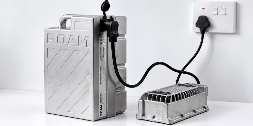 Roam Gen-3 battery connected to its portable home charger and a wall socket