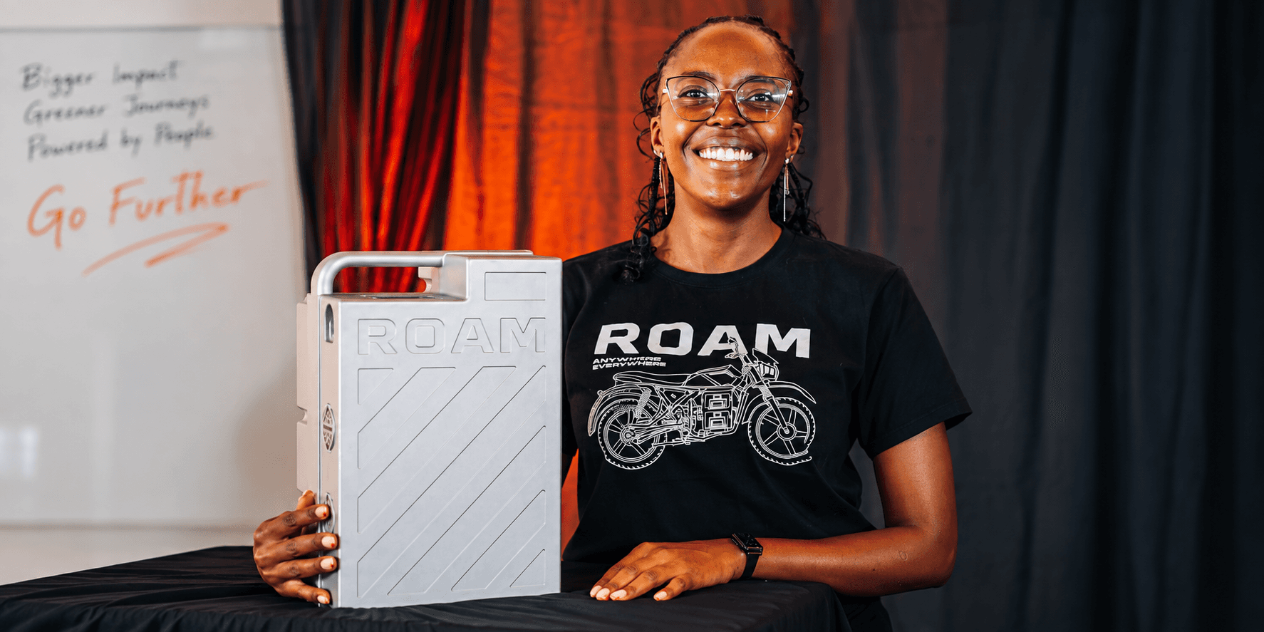 Roam battery engineer Ivy Magara seated beside the Gen-3 battery she led from conception to deployment in Kenya