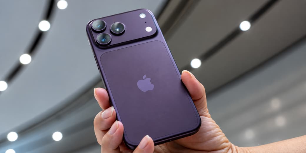 A purple iPhone 18 Pro Max held up in an Apple retail setting.