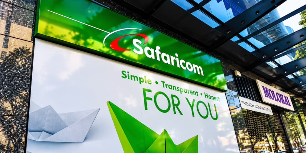 A Safaricom advertising display outside a retail location.