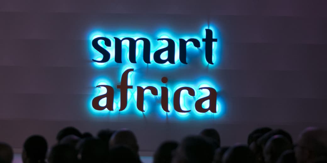 Smart Africa sign lit above a conference audience. Credit: Smart Africa.