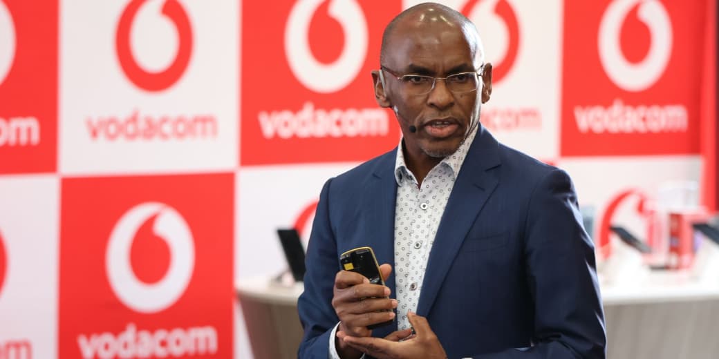 Vodacom executive speaking in front of a branded retail backdrop.