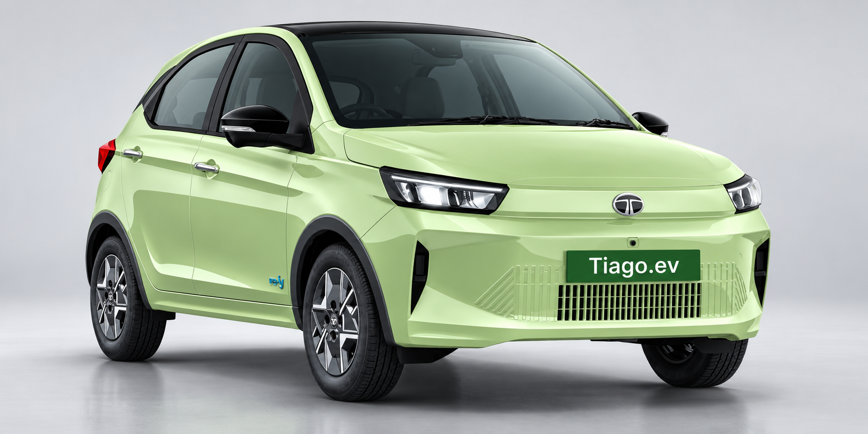 A light green Tata Tiago.ev compact electric car shown against a studio background.