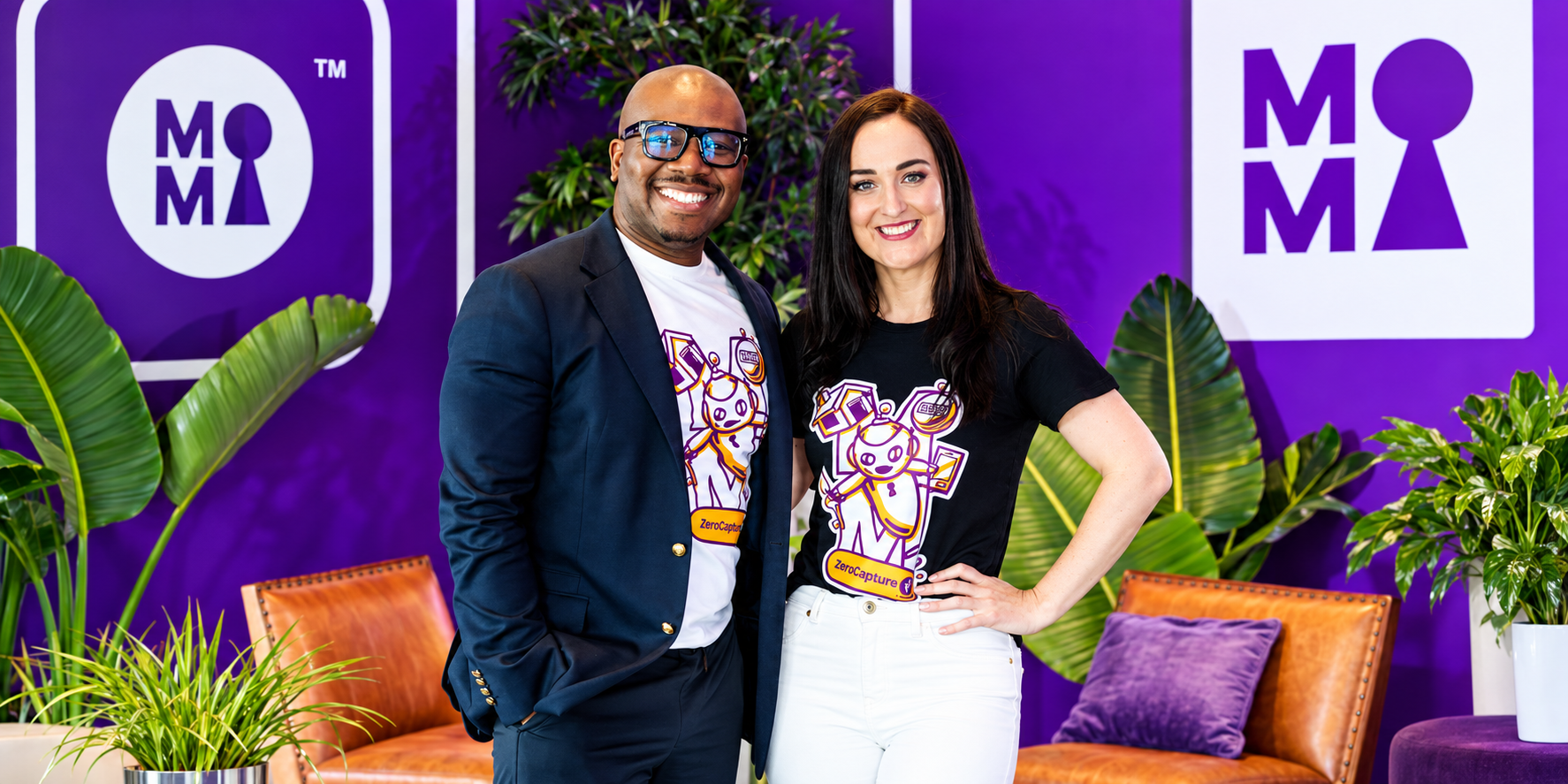 Two MortgageMarket representatives standing in front of the company's purple branding.